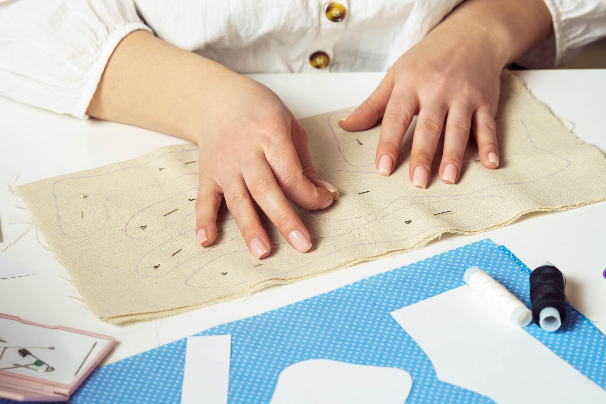 Student stitching on a linen canvas